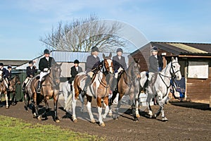 A group of english riders ready for drag hunting with hounds