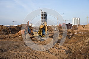 Group of the excavators for dig ground trenching at a construction site for foundation and installing storm pipes. Backhoe digging