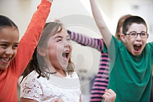 Group Of Excited Children At Stage School Enjoying Dance Class Together