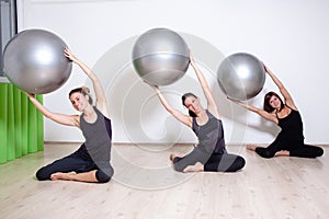Group exercising with pilates balls