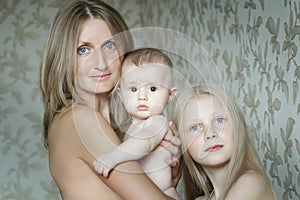 Group family portrait of mother and two adorable siblings