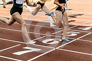 group female athlete crosses finish line sprint race track stadium