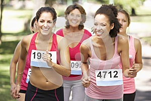 Group Of Female Athletes Competing In Charity Marathon Race