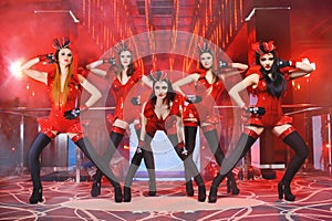 Group of female dancers in red matching outfits performing