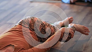 Group of female doing hip side twist yoga