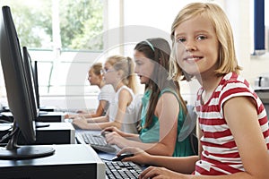 Group Of Female Elementary School Children In Computer Class