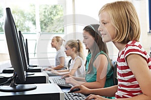 Group Of Female Elementary School Children In Computer Class