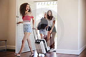 Group Of Female Friends Arriving At Summer Vacation Rental