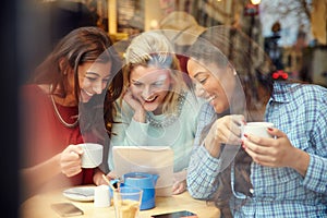Group Of Female Friends In CafÃ¯Â¿Â½ Using Digital Devices