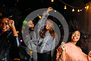 Group of female friends dancing at night