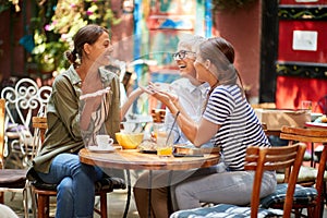 A group of female friends of different generations having fun while they have a drink in the bar after long time. Leisure, bar,