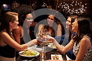 Group Of Female Friends Enjoying Meal In Restaurant