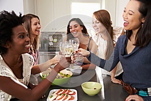 Group Of Female Friends Enjoying Pre Dinner Drinks At Home