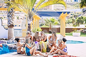 Group of female friends enjoying summer holidays in resort and taking selfie using smartphone. Women eating fresh fruits in skewer