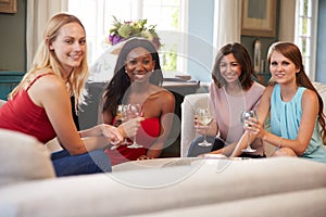 Group Of Female Friends Relaxing At Home With Drinks