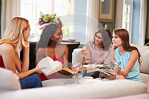 Group Of Female Friends Taking Part In Book Club At Home