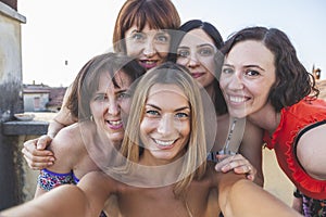 Group of female friends taking a selfie with smarthphone