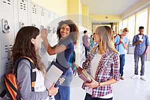 Group Of Female High School Students Talking By Lockers