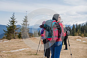 Group of female hikers in mountains during saffron blooming at spring