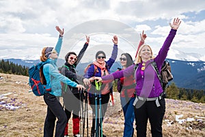 Group of female hikers in mountains during saffron blooming at spring