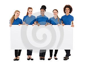 Group Of Female Janitors Holding Billboard