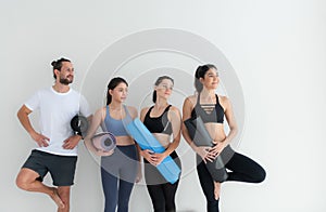 A group of female and male athletes stood and chatted amicably in the studio