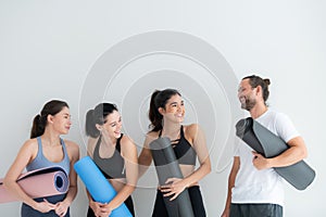 A group of female and male athletes stood and chatted amicably in the studio