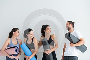 A group of female and male athletes stood and chatted amicably in the studio photo