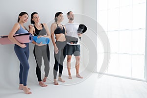 A group of female and male athletes stood and chatted amicably in the studio photo
