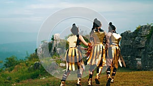 A group of female warriors helps a friend while walking in pain near the royal castle