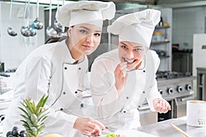 A group of female young chefs prepairing meal in luxury restaurant