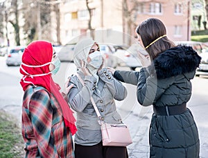 Group of females on street with masks