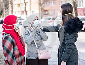 Group of females on street with masks