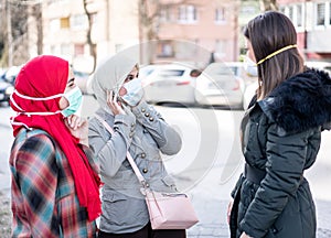 Group of females on street with masks