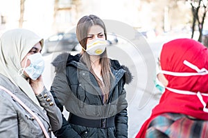 Group of females on street with masks