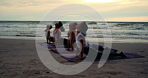 Group females yoga practice in class on mat stretching relaxation exercise with pose fitness sport for healthy