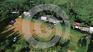 A group on a field preparing for a trek, guided by instructors towards the trail,