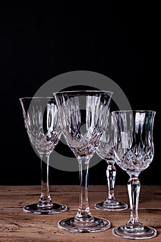 Group of finely chiseled alcohool glasses, close up with black b