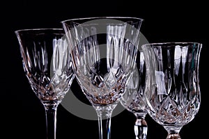Group of finely chiseled alcohool glasses, close up with black b