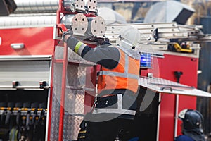 Group of fire men in protective uniform during fire fighting operation in the city streets, firefighters brigade with the fire