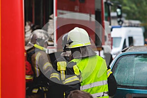 Group of fire men in protective uniform during fire fighting operation in the city streets, firefighters brigade with the fire