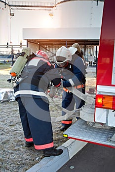 Group of firemen preparing for extinguish fire