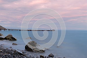 A group of fishermen in the distance on an old abandoned pier