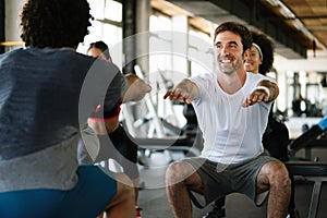 Group of fit people at the gym exercising