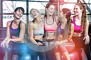 Group of fit woman smiling while sitting on exercise balls