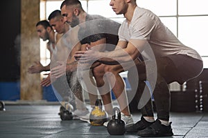 Group of Fit Young Men Preparing for Kettlebell Training