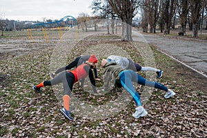 Group fitness workout classes outdoors. Socially Distant Outdoor Workout Classes in public parks. Three women and man
