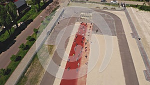 group fitness workout outdoors. fitness outdoors. aerial view. Large group of people, wearing activewear, is exercising