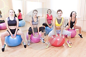 Group of Five Caucasian Female Athletes Having Exercises With Fitballs