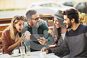 Group of five friends having a coffee together.